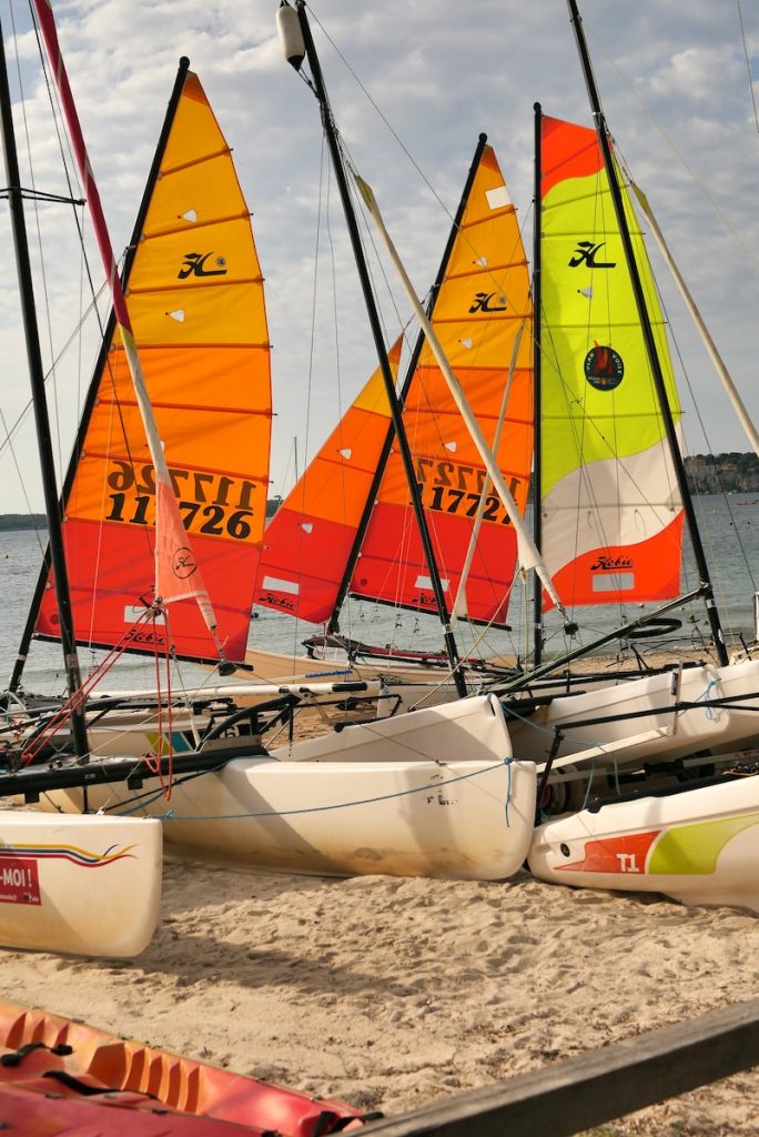 a group of sailboats on a beach